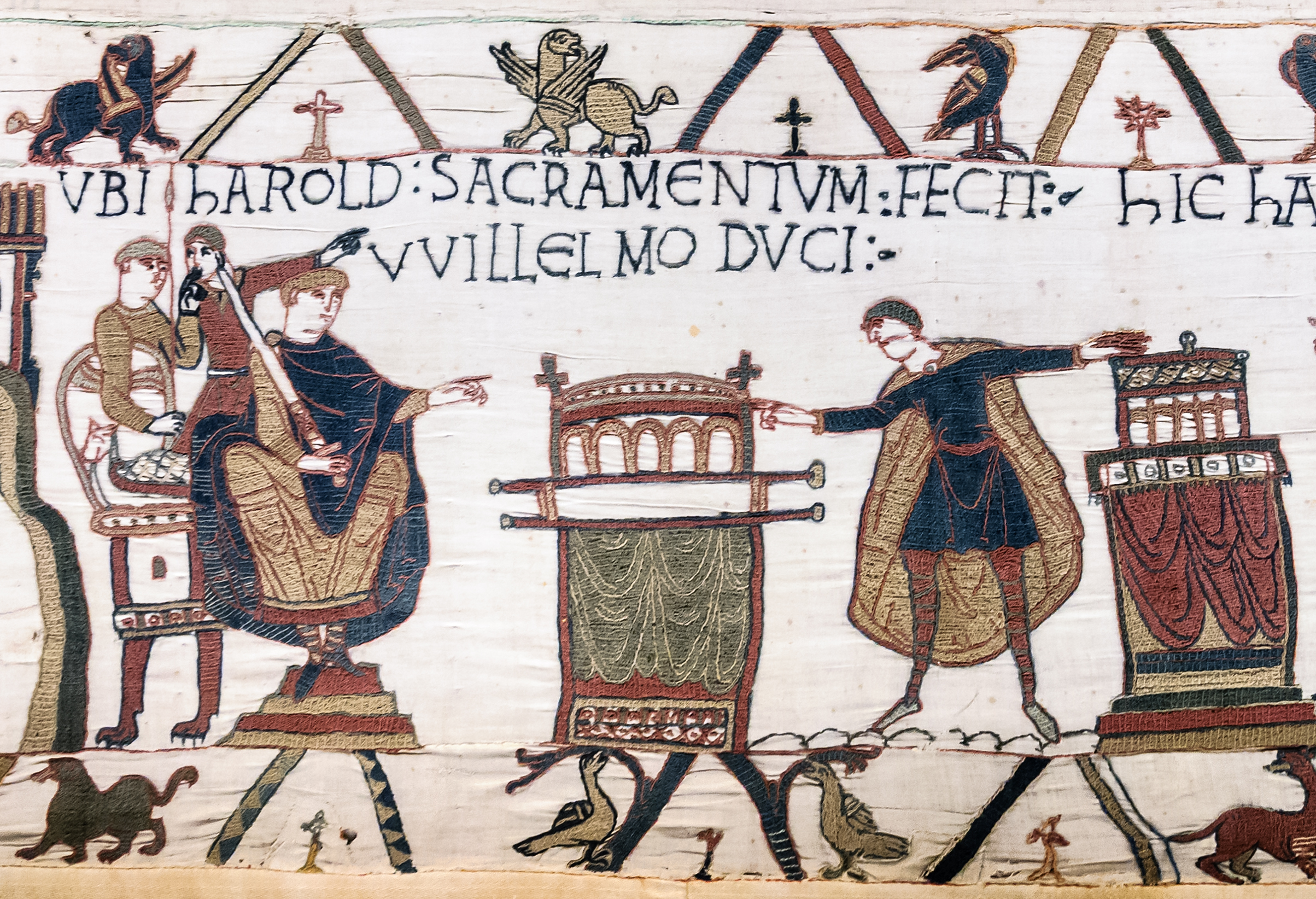 HAROLD SACRAMENTUM FECIT VVILLELMO DUCI ("Harold made an oath to Duke William"): the Bayeux Tapestry shows Harold touching two altars at Bayeux as the duke watches.