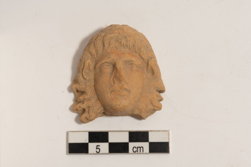 Clay head of a female figure with traces of red pigment. Credit: Greek Ministry of Culture