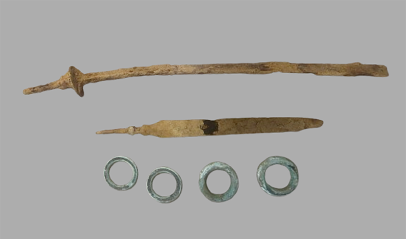 Swords and jewelry discovered during the archaeological survey. Credit: BHT