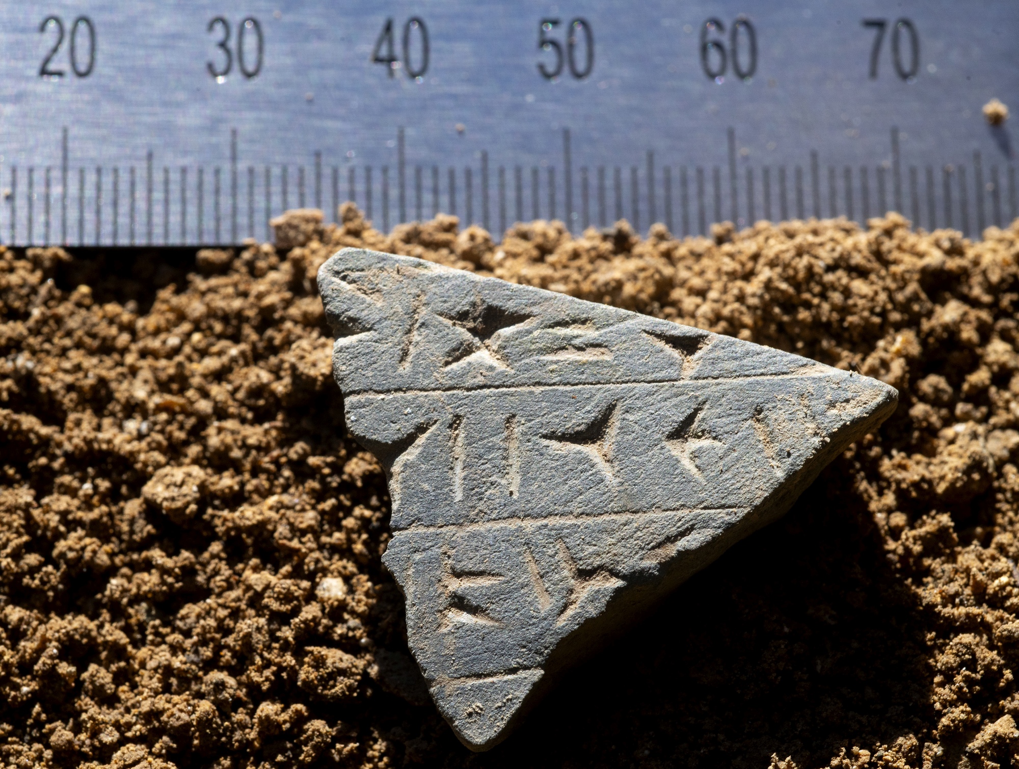 A newly discovered fragment of a mysterious stone tablet featuring cuneiform script. Credit: Správa jeskyní CR