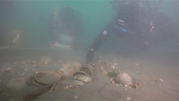 Divers from the National Research Institute of Maritime Cultural Heritage inspect a tightly stacked bundle of celadon bowls on the seabed off Taean, a West Sea coast renowned for its expansive tidal mudflats and historic maritime corridors. Credit: Yonhap News Agency.