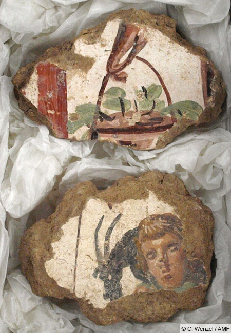 Two of more than 5,000 fragments of painted wall plaster from the cult district. Figurative representations like these are very rare; however, their quality and coloration are exceptional for the Limes region. Credit: C. Wenzel / Archaeological Museum Frankfurt