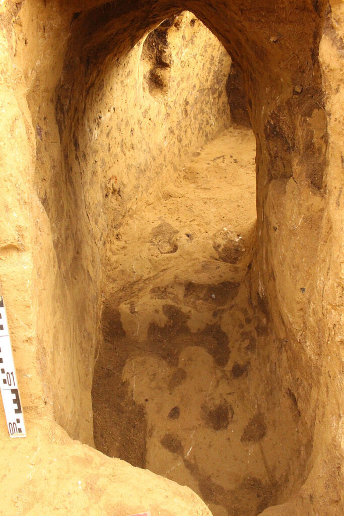 Fully excavated passage of the Erdstall with a pointed gable-shaped ceiling and a small niche in the wall. Passage height approximately one meter, width between 50 and 70 centimeters. Credit: Ulf Petzschmann -  State Office for Heritage Management and Archaeology of Saxony-Anhalt