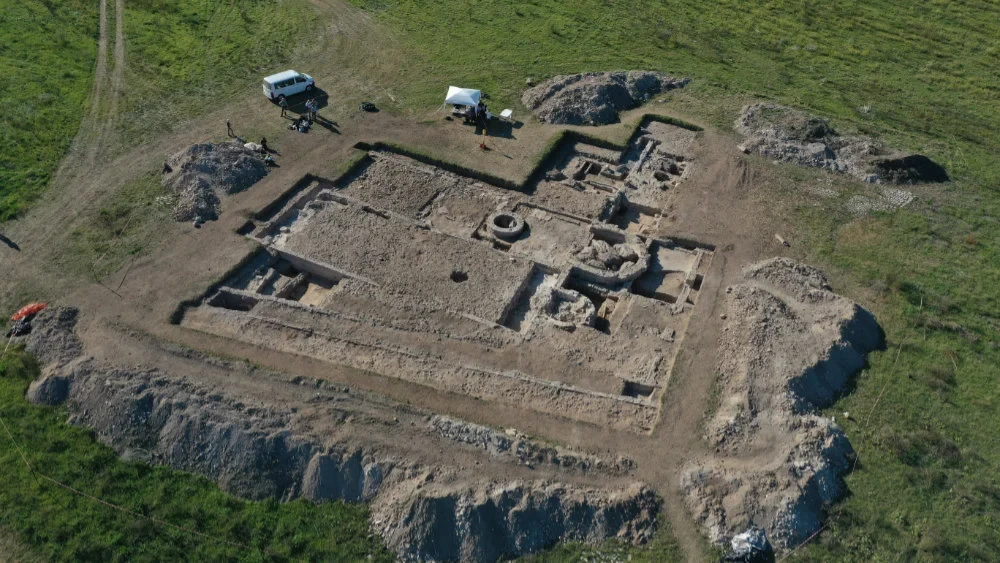 Aerial view of the site: in the foreground, the two parallel wall lines form the double-shell city wall; behind them lies the aula, followed by the baptistery with its circular baptismal basin at the center, and the atrium further behind. Credit: Ostia Project Archive
