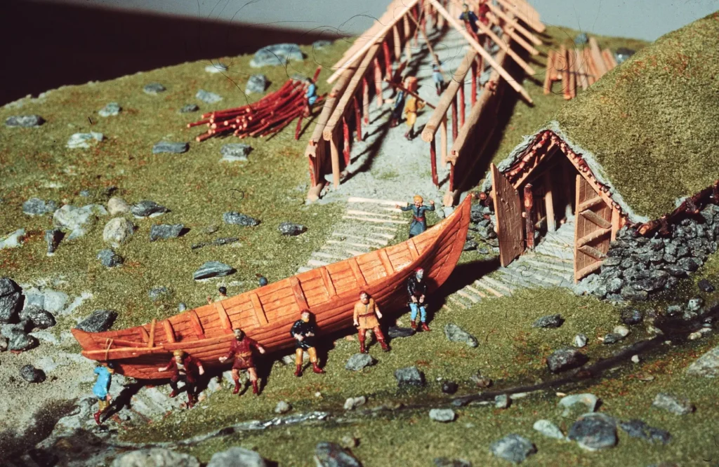 Reconstruction of early seafarers—centuries before the Viking Age—hauling a ship from a boathouse at Karmøy, western Norway, with another large boathouse under construction 1,700 years ago. Model by Rezas Ghoumi. Credit: Terje Tveit / Museum of Archaeology, Stavanger.