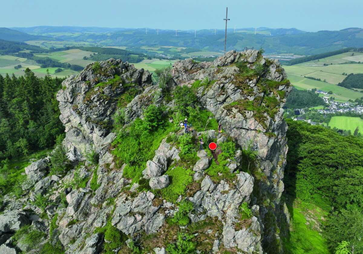 View of the Feldstein rock from the southeast. The archaeological discovery site is marked by the red dot. Photo: LWL Archaeology for Westphalia / F. Geldsetzer