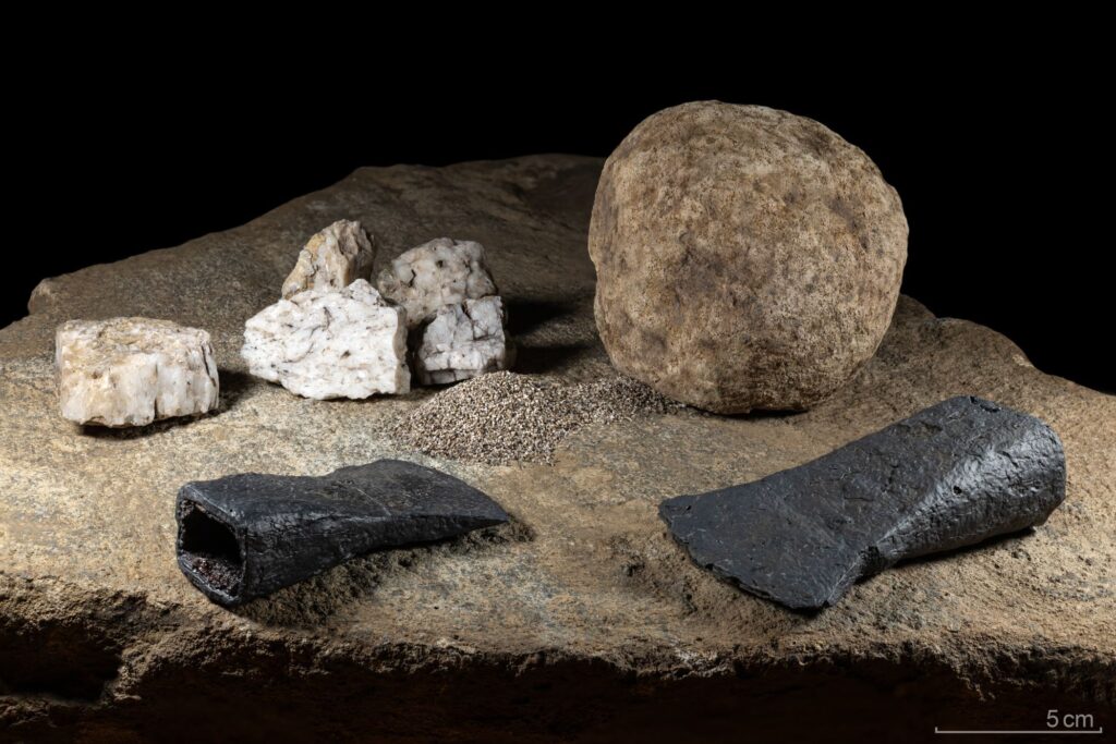 Quartz, hammerstone, axes, and stone slab allow researchers to reconstruct an Iron Age ritual on the Feldstein. Credit: LWL Archaeology for Westphalia / T. Poggel