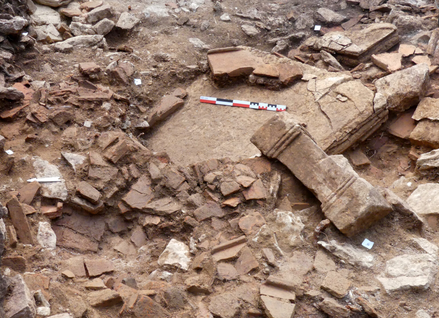 One of the statue pedestals and the large stone table being excavated within the Phase 4 layers of Temple M3 at the Mancey sanctuary. Credit: Grégory Compagnon (2026), Le Fil d'ArAr