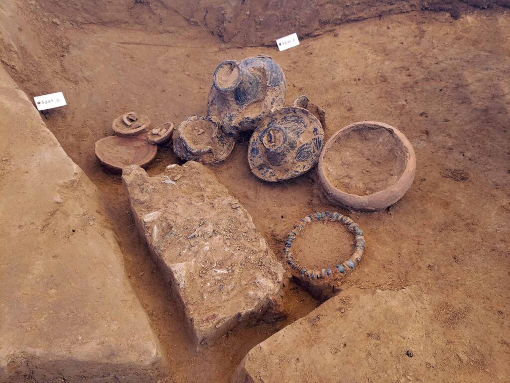 View of a grave with a bead necklace in the foreground. Credit: F. Simon – Inrap