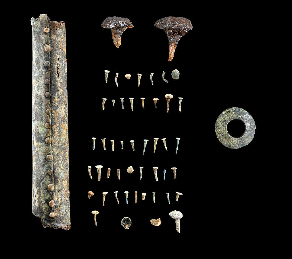 Among the finds in the looters’ shaft were a wooden wheel spoke likely once covered with bronze sheet, numerous small bronze nails, and several large iron nails used to fasten iron wheel rims to wooden wheels. Credit: State Office for Monument Preservation (LAD) at the Regierungspräsidium Stuttgart / Yvonne Mühleis.