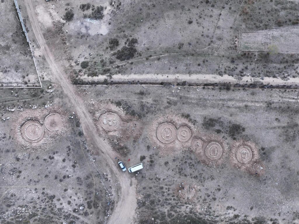 Aerial view of early Saka-period kurgan burials and circular stone structures uncovered during rescue excavations near Cholpon-Ata, Kyrgyzstan. Credit: Ministry of Culture, Information and Youth Policy of the Kyrgyz Republic