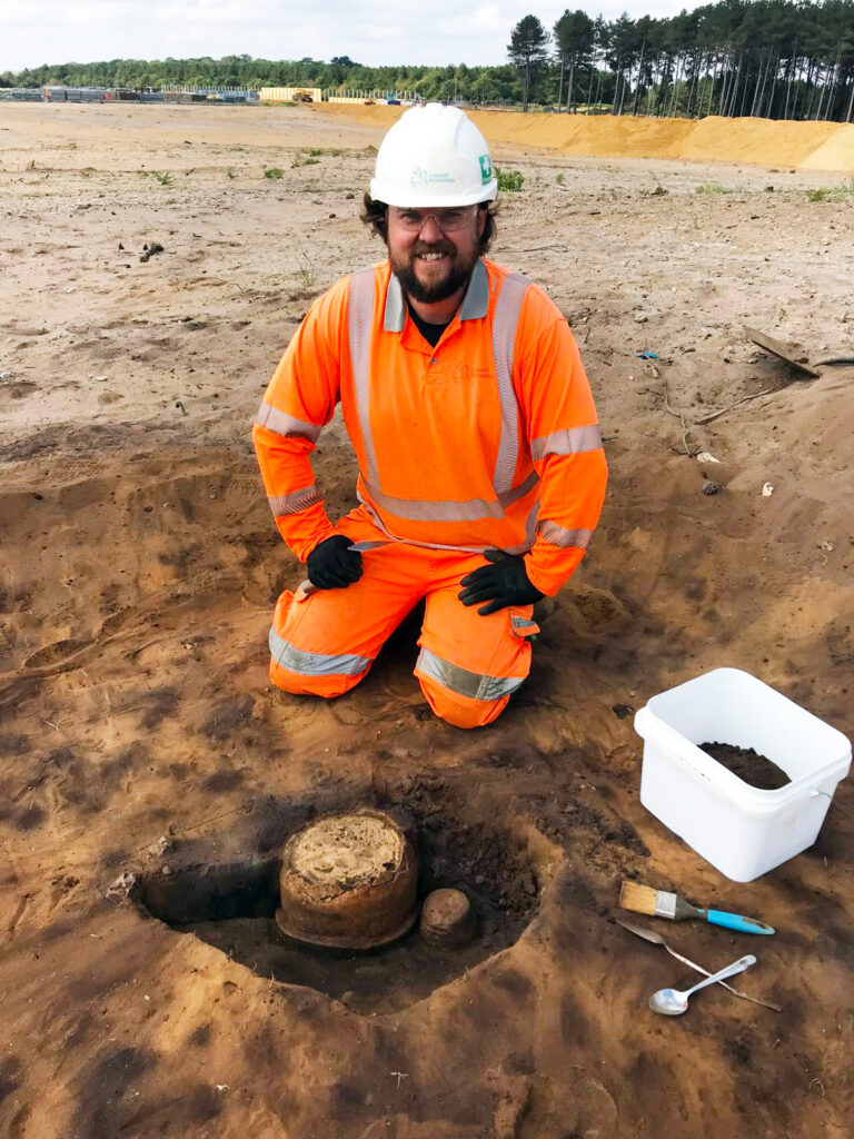 Will (Archaeologist) with the Collared urn found on site. Credit: Oxford Cotswold Archaeology
