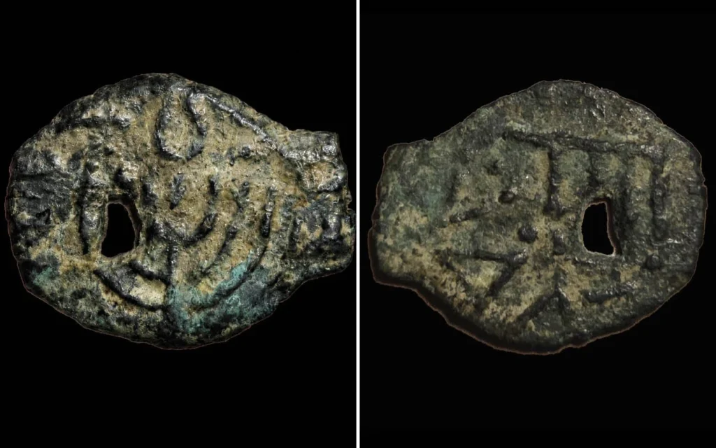 A rare 2,000-year-old coin showing the Temple menorah and showbread table was returned to Israel on May 12, 2026, after a joint U.S.-IAA investigation. Credit: Eitan Klein / Israel Antiquities Authority
