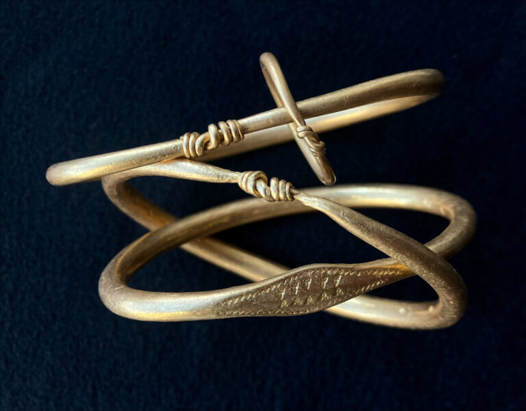 Three of the Viking gold arm rings are smooth, while one stands out with zigzag and triangular decoration. Another ring contains a smaller ring of the same type. Credit: Nordjyske Museer
