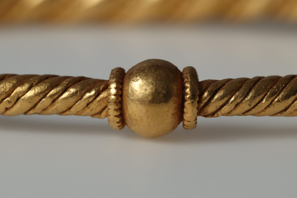 Two of the rings are nearly identical, made from two solid twisted rods and finished with simple wrapped closures known as running knots. A third follows the same basic design but has a bead-like terminal and a thin twisted gold wire set into the groove between the heavier strands. Credit: Nordjyske Museer