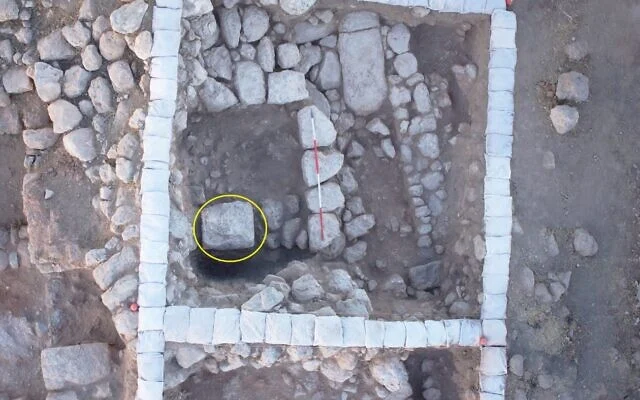 Aerial photograph of Room 101B after the stone layer was removed at the end of the 2014 season (looking to the south), with the large stone (circled). Note the remains of the Persian Period foundations still visible outside the square (photo: Sky View). Credit: Faust, A. (2026)