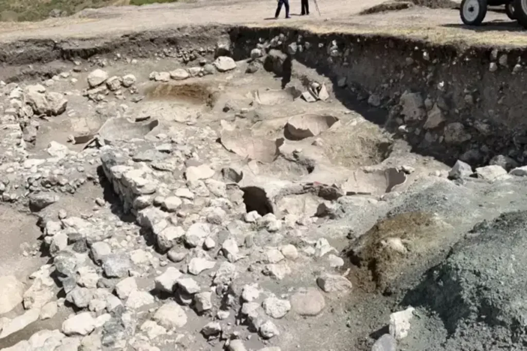 Excavations have so far exposed 16 large storage jars set into a steep hillside that had been carefully terraced to accommodate the building. Credit: AA