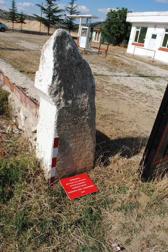 Inscription featuring a quotation from Homer's Odyssey — describing the hero's many trials and hardships at sea — found at a gas station in Özdenk, Alpu District, having originally been brought there from Ayvalı (Belkese village).