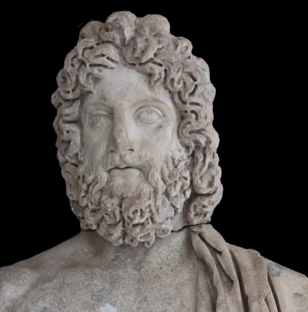 A close-up of Asklepios's face and beard, showing the detailed carving typical of Roman Imperial-era sculpture, late 2nd century AD.