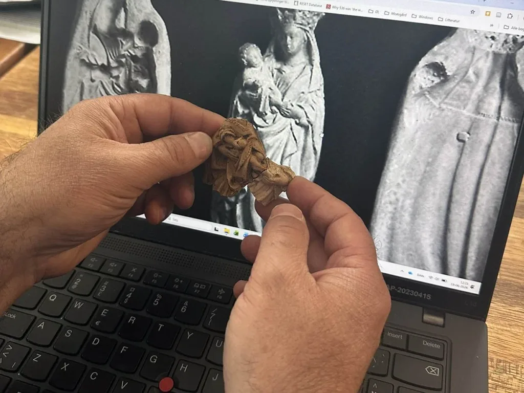 Fragments of a statue depicting the Virgin Mary and the Christ Child, among the artifacts uncovered at the Á Sondum archaeological site. 