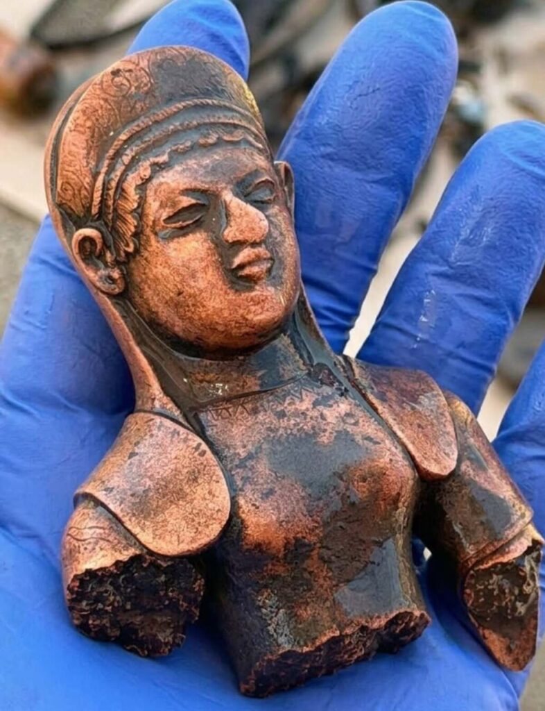 Two bronze statuettes and a rare bronze plate recovered from the well, remarkably preserved after 2,500 years underground.