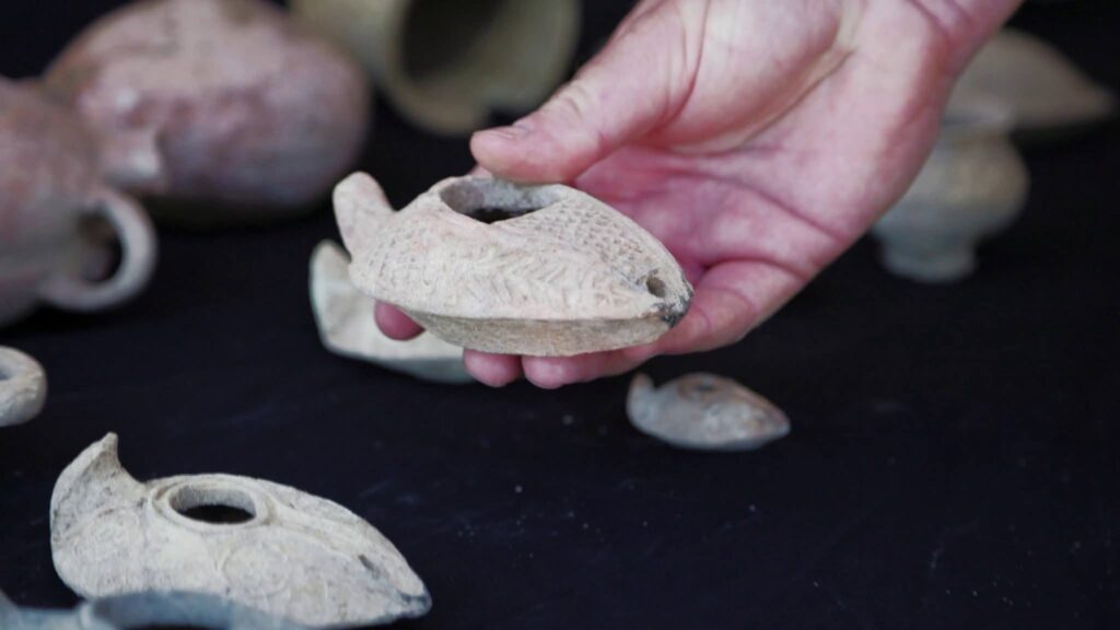 Dozens of pottery vessels and complete oil lamps were discovered alongside bronze tableware and cosmetic implements. Credit: Emil Aljem and Asaf Peretz, Israel Antiquities Authority