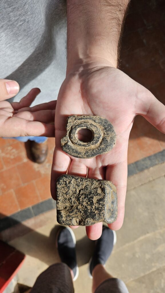 The ring blank and worked shale provide a glimpse into the different stages of ring manufacture at Govan Old.