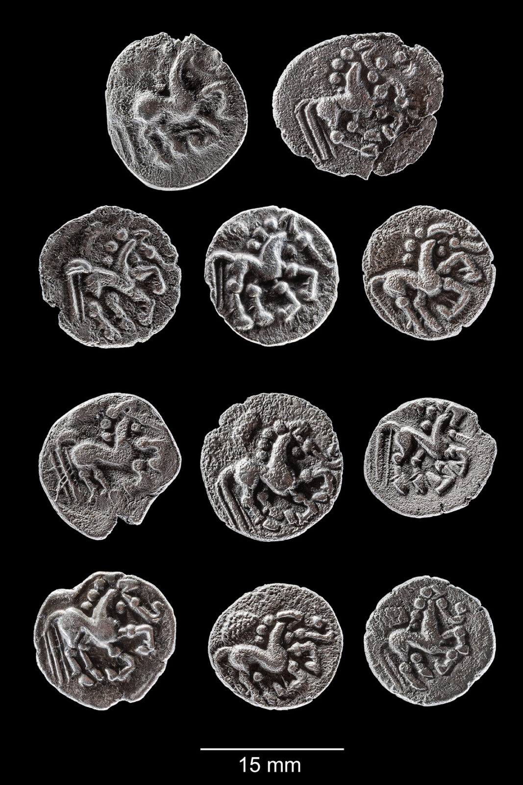 The complete group of 11 Celtic Prague-type quinarii discovered at Singen, with stylized horse motifs visible on the reverse.
