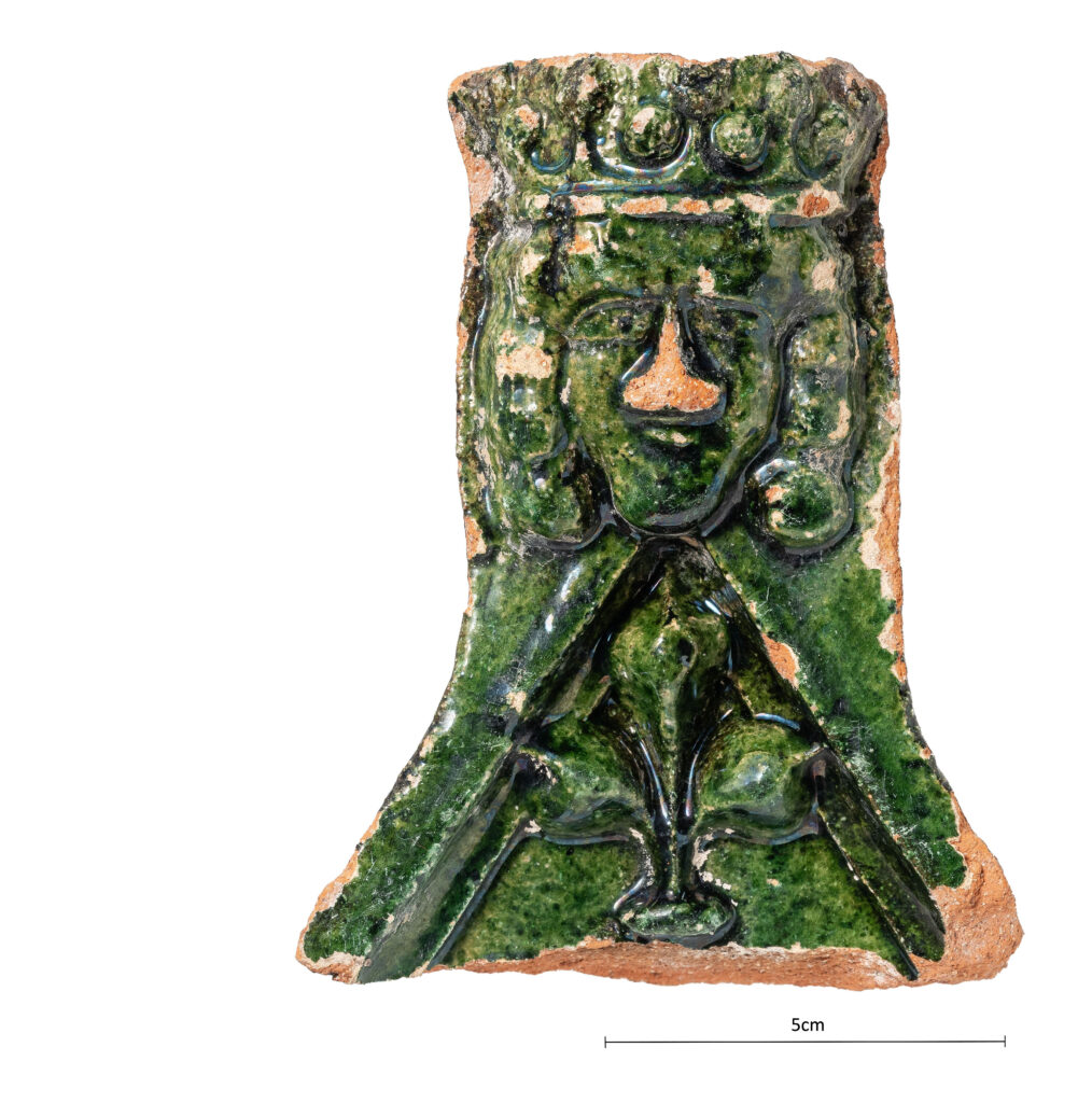 A green-glazed stove tile discovered at Gnadental Convent.