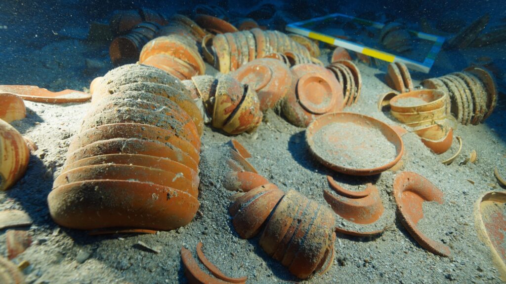 Stacked ancient ceramic plates and bowls preserved at the Adrasan shipwreck site.