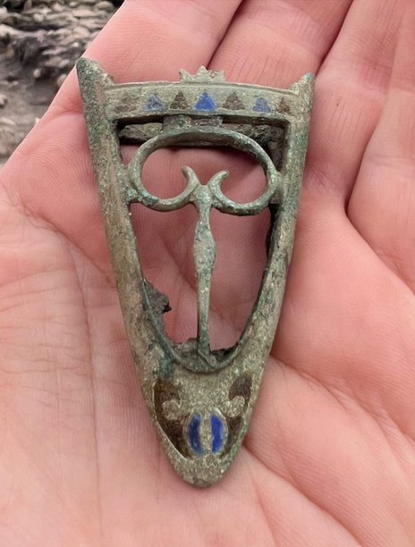 Archaeologists working at the site have uncovered a copper-alloy scabbard chape decorated with enamel, found within a 2nd-century archaeological context. Credit: Vindolanda Trust