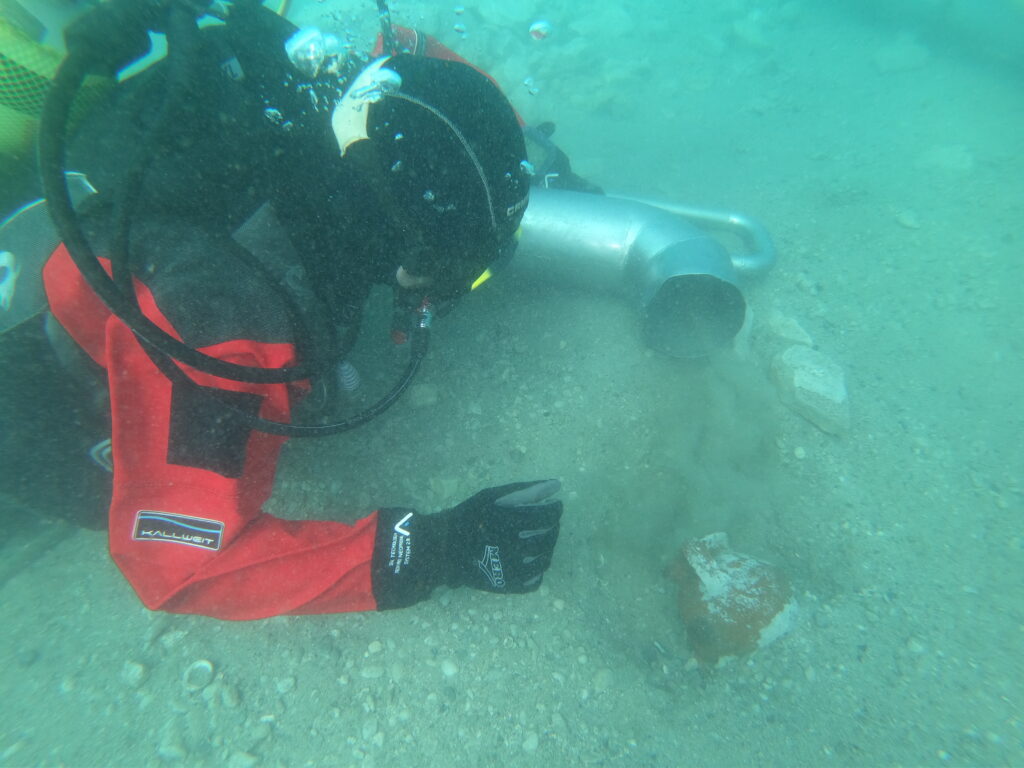 Underwater archaeologist examining archaeological material on the seabed in Polače Bay, Croatia.