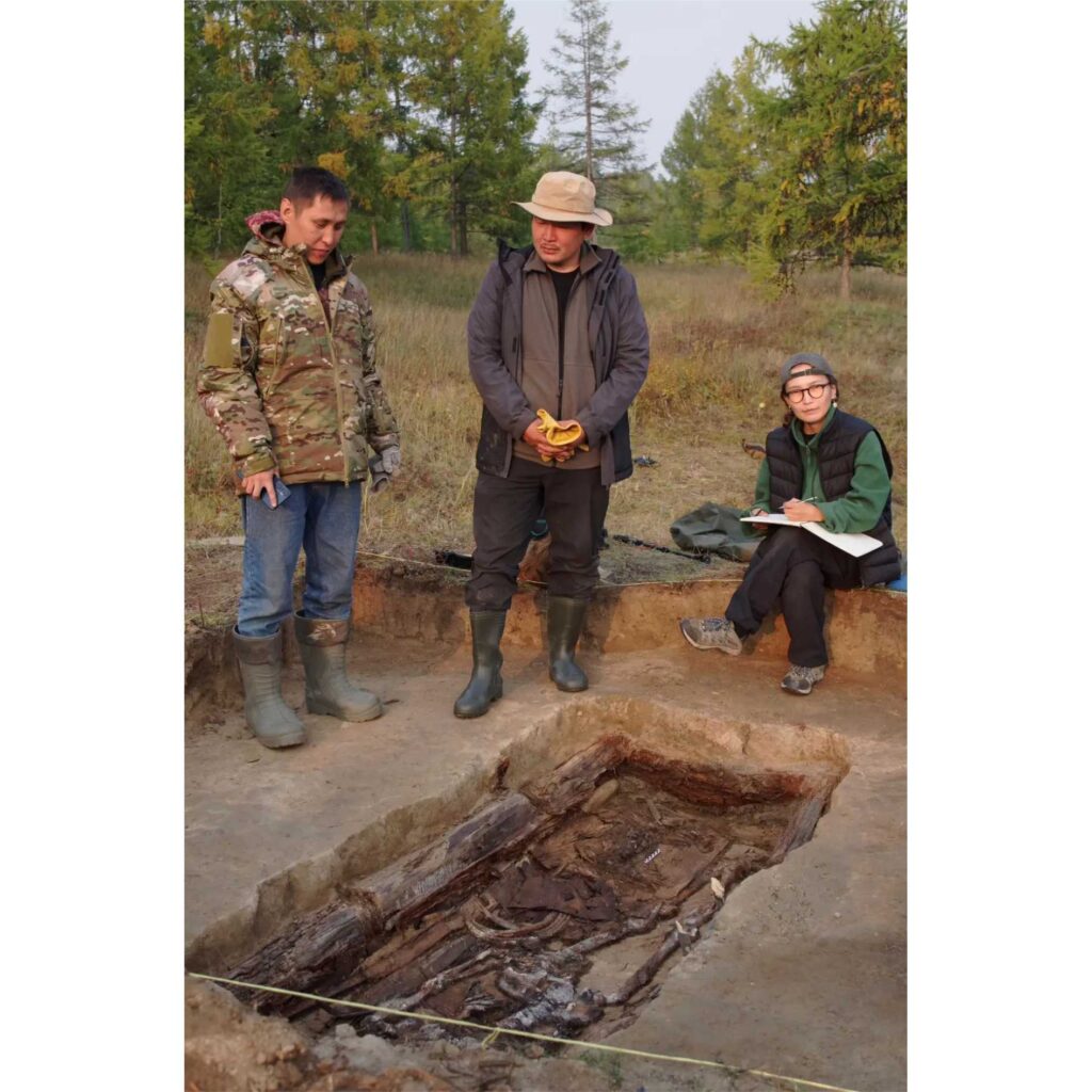 Archaeologists documenting a centuries-old warrior's burial at an excavation site in Siberia.