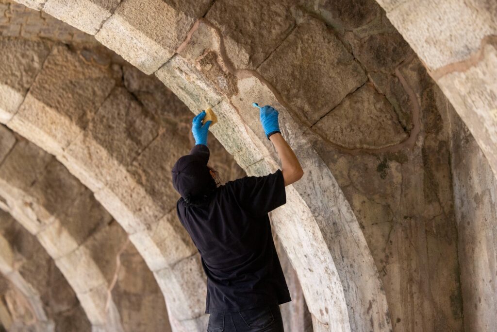 Conservator working on an ancient plastered arch inside the Roman Agora of Smyrna in İzmir, Türkiye.