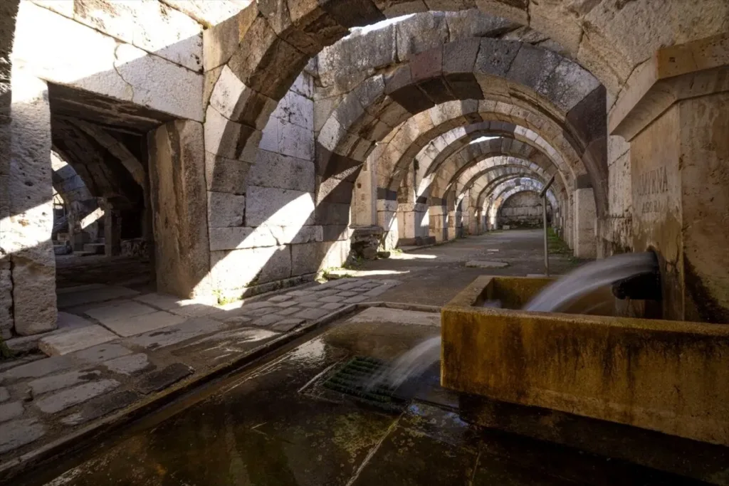 Flowing water and ancient stone arches inside the Roman Agora of Smyrna in İzmir.