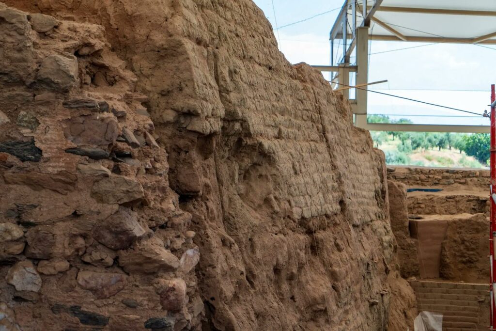Close-up of the ancient Lydian defensive wall at Sardis, showing its surviving mudbrick layers and stonework.