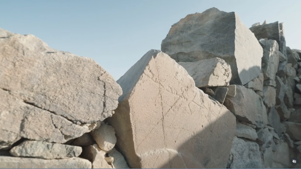 Inscribed stone set among the masonry of the early Islamic mosque at Al-Ma'mala.