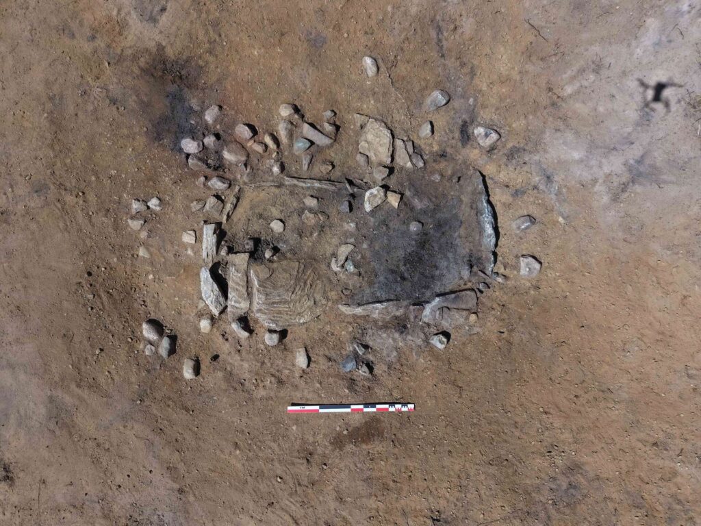 Overhead view of a Late Neolithic stone tomb in Norway, showing the exposed burial chamber before excavation.