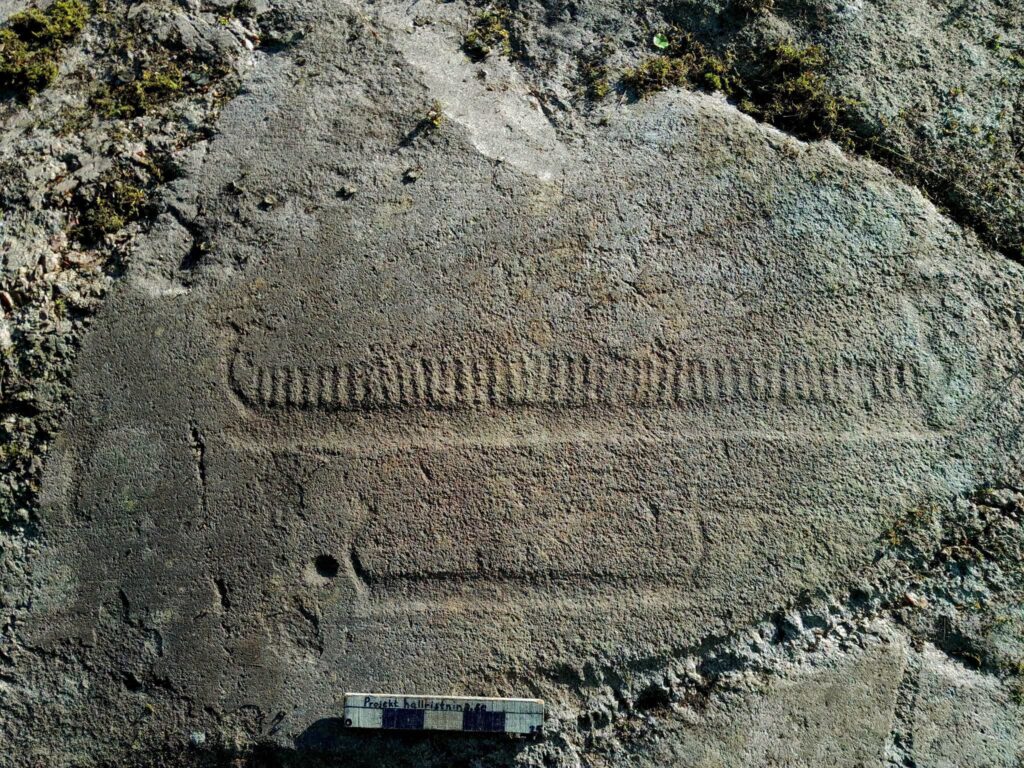 Partially cleaned ship carving on a sloping granite rock surface at Trättelanda in the Tanum World Heritage area.