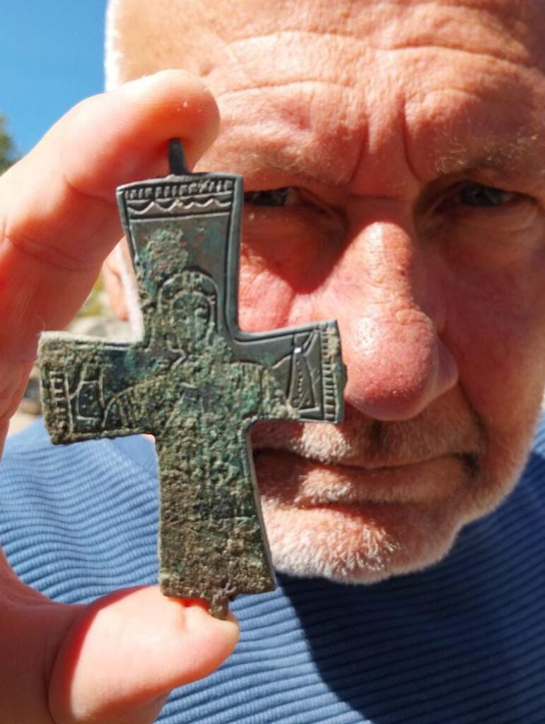 
Prof. Nikolay Ovcharov holds an 11th-century bronze reliquary cross decorated with an image of the Virgin Mary, discovered at Perperikon in Bulgaria.