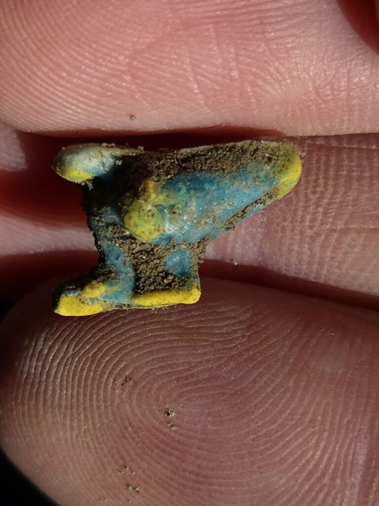 Small ancient Roman pendant shaped like a winged shoe, part of a collection of protective amulets discovered in Pompeii.