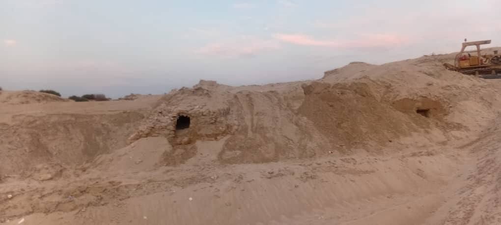 Wide view of archaeological remains emerging from sandy terrain at Shatt al-Badin in eastern Libya.