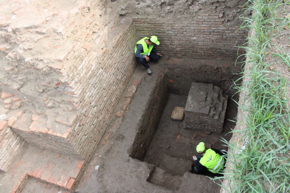 Archaeologists examining ancient brick foundations and stone walls during excavations at Gabala, Azerbaijan.