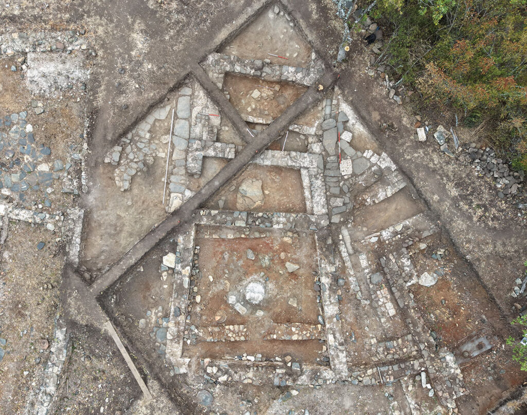 Aerial view of the Thracian pagan temple at Balak Dere, Bulgaria, showing excavated stone foundations and interconnected chambers.