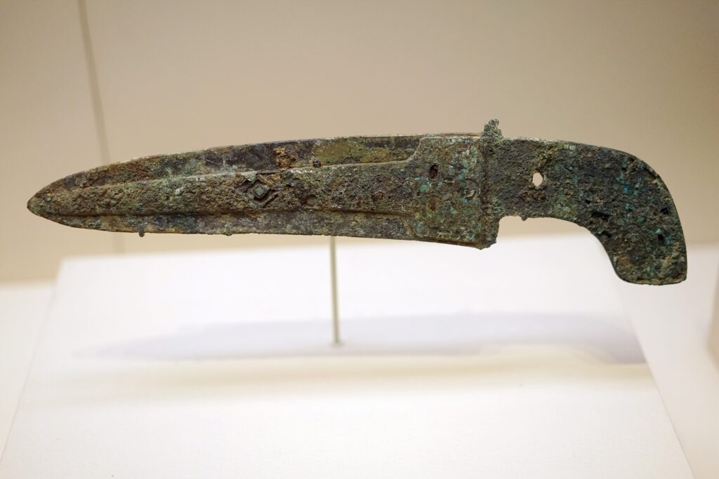 Turquoise-inlaid bronze dagger-axe among the weapons discovered in the tomb of Fu Hao, the Shang Dynasty warrior queen.