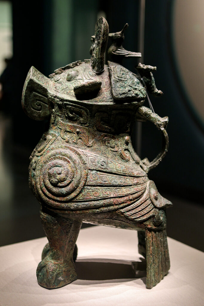 Shang Dynasty bronze owl-shaped zun ritual vessel with intricate decorative details and inscriptions identifying Fu Hao, displayed at the National Museum of China.
