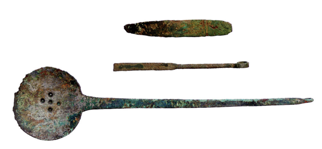 Byzantine-style bronze strainer spoon and spatulas found in a 1,400-year-old Avar woman's grave in Hungary.