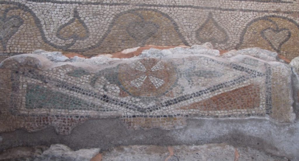 Early Byzantine floor mosaic featuring a cross-shaped protective symbol at the southeastern entrance of the Church of the Four Rivers in Hadrianoupolis, Türkiye.