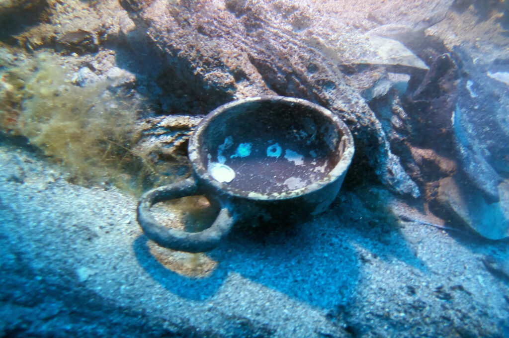 Ancient black-glazed ceramic drinking cup discovered underwater at the Gnjilna shipwreck near Vis Island.