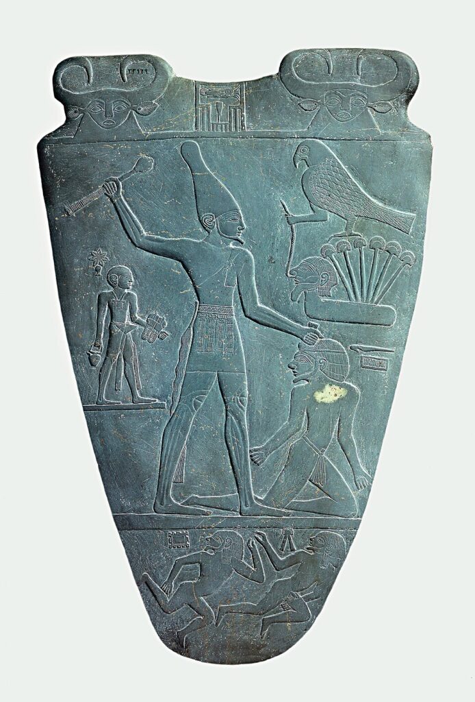King Narmer raises a mace over a captive on the ancient Egyptian Narmer Palette.